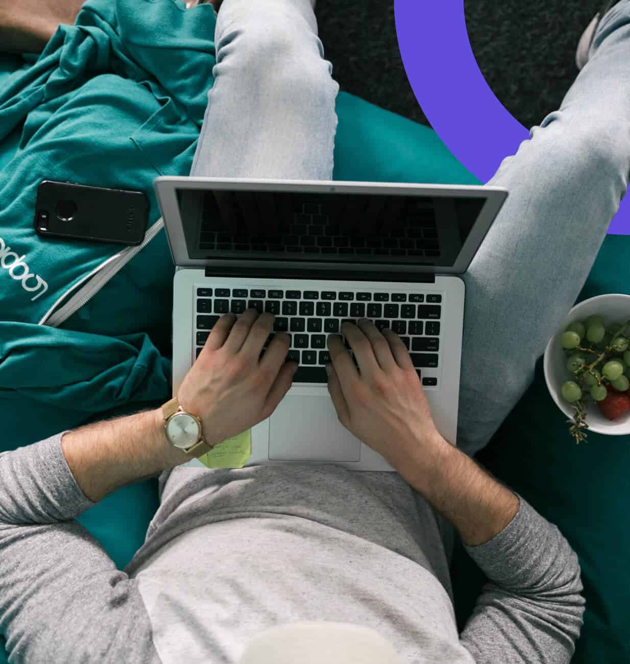 A Looper is working on a laptop from home