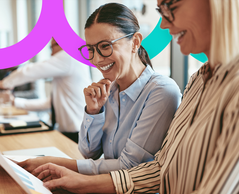 Two women working together at a laptop.