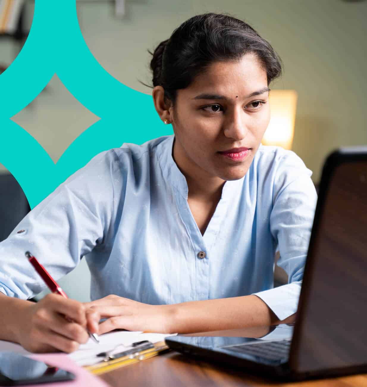 A young Indian female is working in front of her work laptop